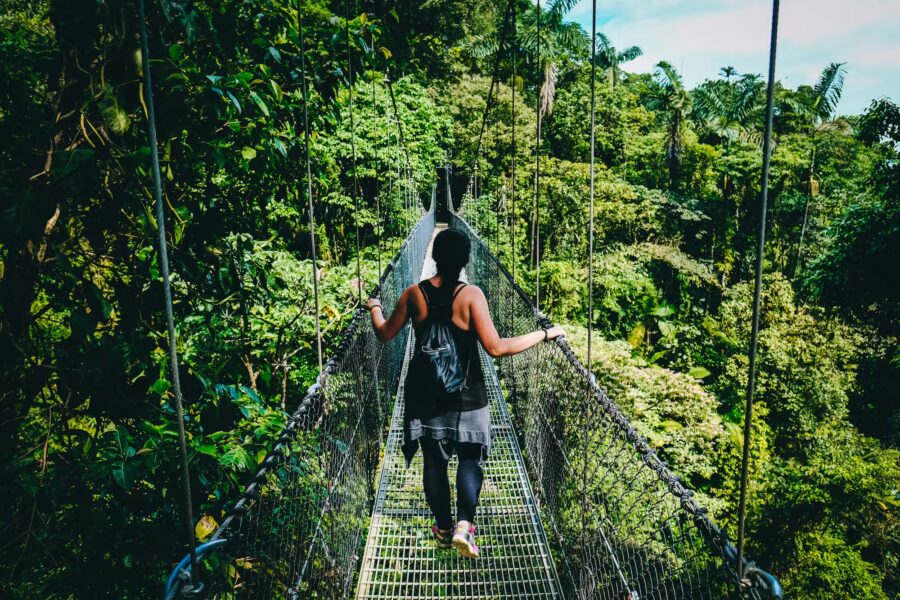 Walking on rope bridge in Costa Rica - How to buy Costa Rica real estate property as an American