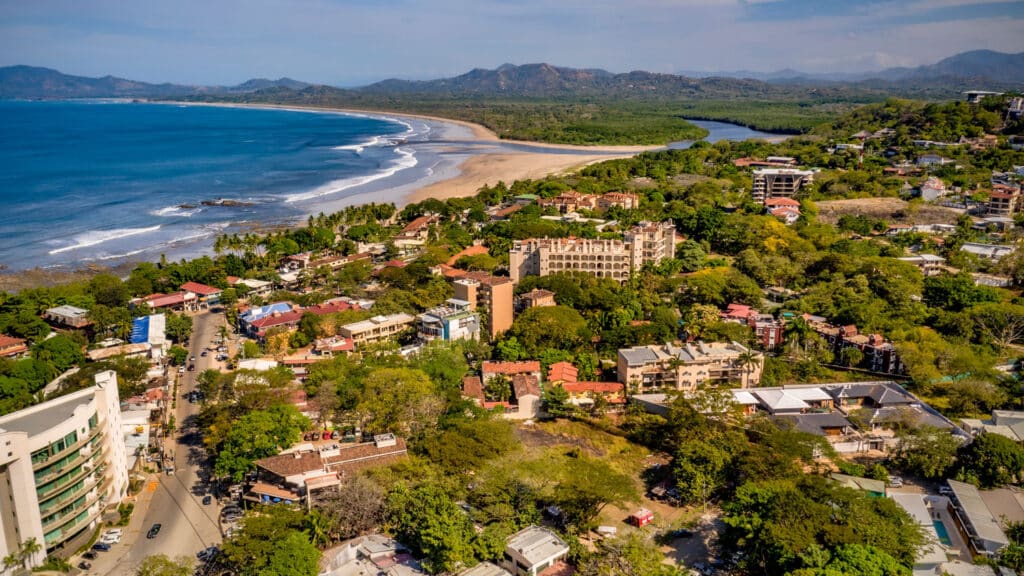 Aerial view of a beach town and coastline in Costa Rica