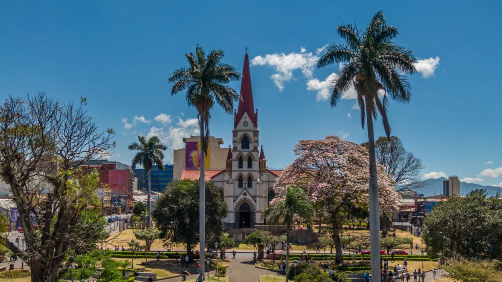 Church and palm-lined park in San José, Costa Rica