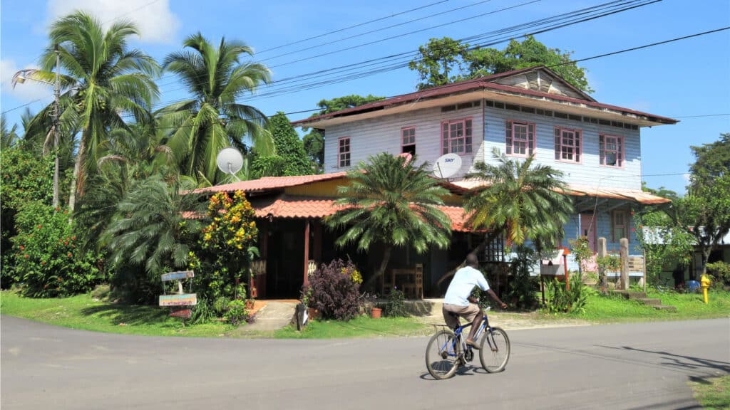 tropical home and cyclist on a quiet street in Costa Rica