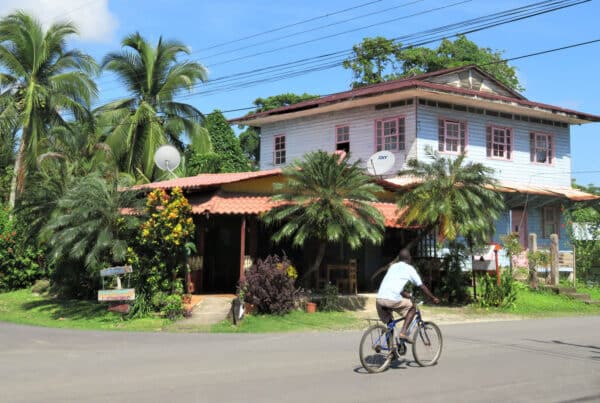 tropical home and cyclist on a quiet street in Costa Rica