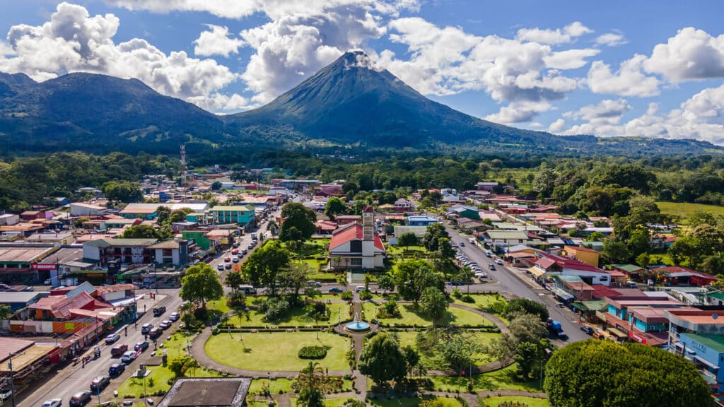 Arenal Volcano towering over the central park and downtown plaza in La Fortuna, Costa Rica