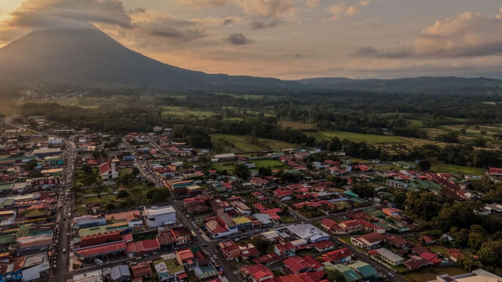 La Fortuna town at sunset with Arenal Volcano rising in the background