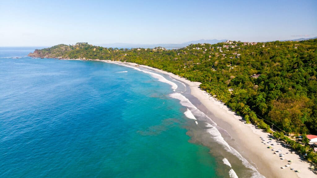 Turquoise water and rainforest meeting the sand at Manuel Antonio on Costa Rica's Central Pacific coast
