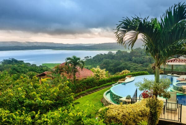 Hillside villa with infinity pool and tropical gardens overlooking Lake Arenal, a prime example of investment property in Costa Rica
